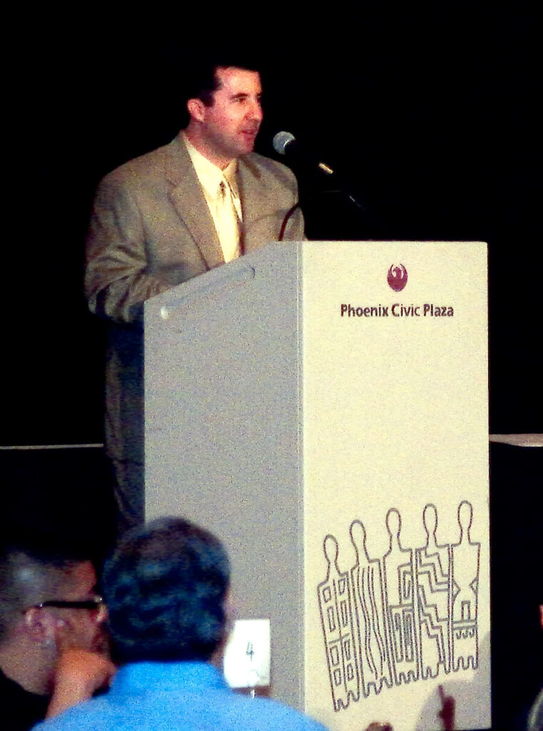 Dr. Alan F. Castillo speaking on artificial intelligence and federal cloud architecture at Phoenix Civic Plaza